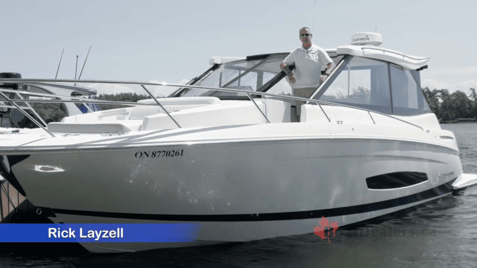 Rick Layzell standing aboard a Regal 36 Grande Coupe, preparing for a video review with the boat docked and open for demonstration.
